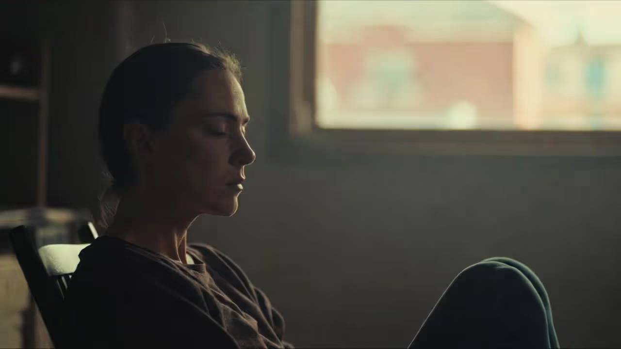 Adult indoors during winter morning with emotionally numb expression